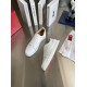 Christian Louboutin Louis Junior White Leather Trainers Angled Pair Angled pair view of Christian Louboutin Louis Junior white leather trainers displaying red sole accent