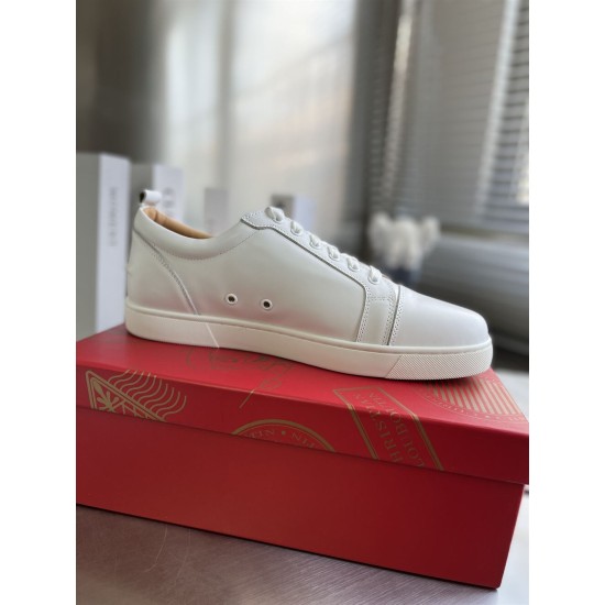 Christian Louboutin Louis Junior White Leather Trainer Lateral Profile Lateral side view of single Christian Louboutin Louis Junior white leather trainer resting on red shoe box