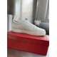 Christian Louboutin Louis Junior White Leather Trainer Lateral Profile Lateral side view of single Christian Louboutin Louis Junior white leather trainer resting on red shoe box
