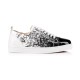 Full side profile of Christian Louboutin low-top trainer on plain white background in black and white