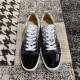Top-down view of a pair of Christian Louboutin black and white printed trainers