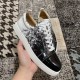 Side profile of Christian Louboutin black and white low-top trainers with white rubber sole