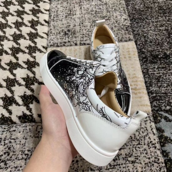 Rear angle view highlighting the white heel tab and collar of Christian Louboutin trainers in black and white