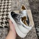 Rear angle view highlighting the white heel tab and collar of Christian Louboutin trainers in black and white