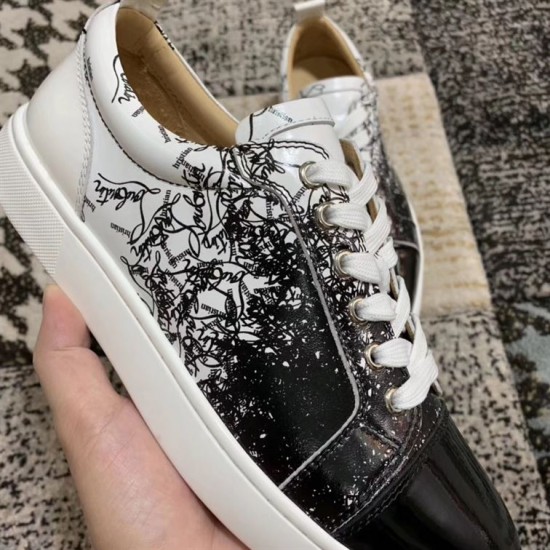 Detailed close-up of the black and white graphic script print on Christian Louboutin trainers