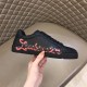 Christian Louboutin Black Trainer Graphic Side Detail in black and red Lateral side view of Christian Louboutin black trainer with red graphic text