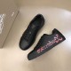 Christian Louboutin Black Low Top Trainers Angled View in black and red Angled top view of pair of Christian Louboutin black trainers in black and red