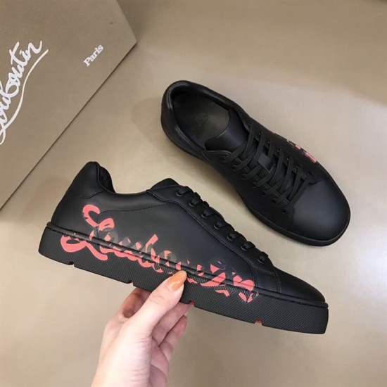 Christian Louboutin Black Trainer Side Profile in black and red Hand holding Christian Louboutin black low top trainer showing red side script