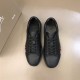 Christian Louboutin Black Leather Trainers Pair Overhead View in black and red Top-down view of pair of Christian Louboutin black leather trainers in black and red