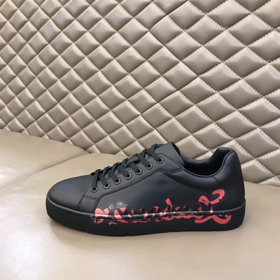 Christian Louboutin Black Trainer Lateral View in black and red Lateral profile view of Christian Louboutin black leather trainer on display in black and red
