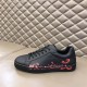 Christian Louboutin Black Trainer Lateral View in black and red Lateral profile view of Christian Louboutin black leather trainer on display in black and red
