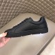 Christian Louboutin Black Trainer Medial Side View in black and red Inner medial view of Christian Louboutin plain black leather trainer upper in black and red