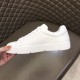 Medial side view of Christian Louboutin white leather trainer showing plain inner panel in white and red