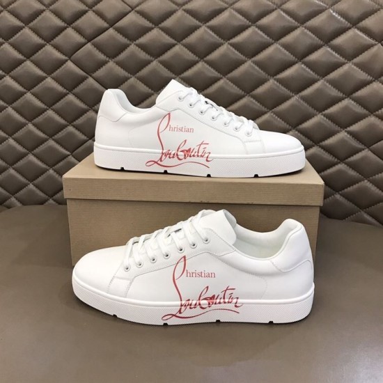 Pair of Christian Louboutin white leather trainers stacked beside shoebox showing script logo in white and red