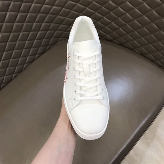 Front overhead view of Christian Louboutin white leather trainer showing toe box and eyelets in white and red