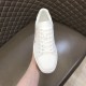Front overhead view of Christian Louboutin white leather trainer showing toe box and eyelets in white and red