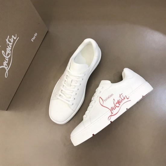 Angled top-down layout of Christian Louboutin white trainers on neutral background in white and red