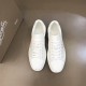 Top-down view of pair of Christian Louboutin white leather script logo low top trainers in white and red