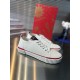 Three-quarter view of Christian Louboutin white trainers with red midsole trim