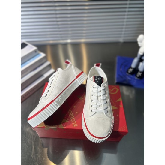 Top-down view of white canvas low top trainers displaying branded tongues in white and red