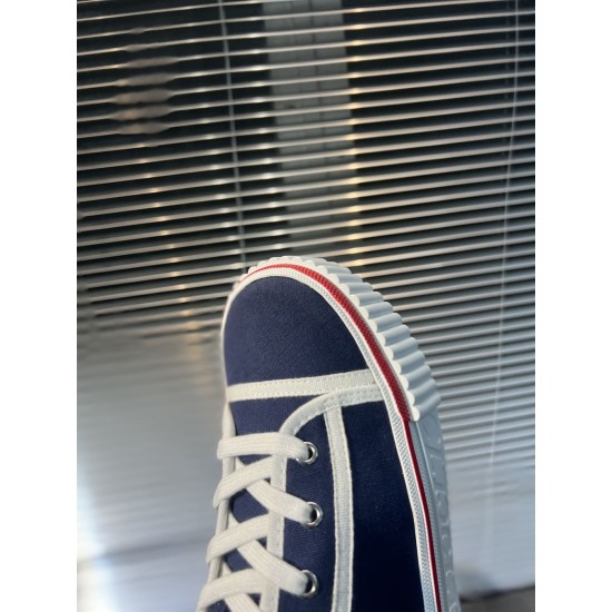 Detailed view of the toe cap and white piping on navy Christian Louboutin Pedro Junior Trainers in navy and red