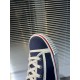 Detailed view of the toe cap and white piping on navy Christian Louboutin Pedro Junior Trainers in navy and red