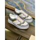 Gucci Monogram Low Top Top Angle View in beige and white Top-down angled view of Gucci beige and grey leather monogram trainers resting on wooden shelf in beige and white