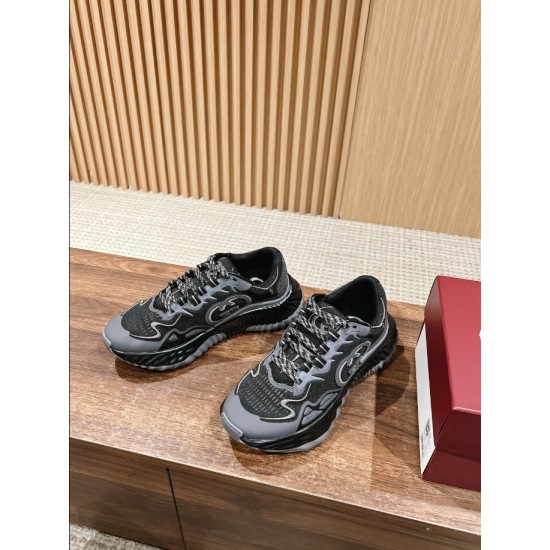 Gucci Ripple Trainers Pair View in black and grey Pair of Gucci Ripple grey and black trainers resting on a wooden surface