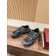 Gucci Ripple Trainers Pair View in black and grey Pair of Gucci Ripple grey and black trainers resting on a wooden surface
