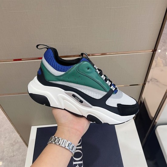 Dior B22 Blue Green Trainer Handheld Lateral View Hand holding Dior B22 blue and green trainer showcasing lateral side details