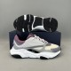 Dior B22 trainer displayed with black sculpted rubber outsole visible in grey and purple