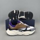Dior B22 Trainer and Sole Detail in brown and purple Dior B22 side profile trainer resting below black tread sole layout in brown and purple