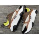 Dior B22 Brown Low Top Trainers Pair View in brown and lime Pair of Dior B22 brown leather trainers resting on a patterned carpet surface in brown and lime