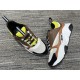 Dior B22 Brown Trainers Angled Top View in brown and lime Angled top view showing the toe box, lacing system, and lime green collar of Dior B22 brown trainers