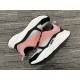 Lateral side and medial side views of Dior B22 trainers in pink and white