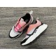 Pair of Dior B22 pink white and black trainers shown from above angle