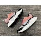 Side angles of pink white and black Dior B22 trainers on display