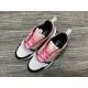 Top down view of a pair of Dior B22 trainers in pink and white