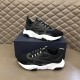 Dior B22 Black Trainers Pair Display in black and white Pair of Dior B22 black trainers arranged on and beside a navy blue shoe box in black and white