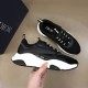 Dior B22 Black Trainer Profile Held in Hand in black and white Side profile view held in hand showing the sculpted white sole of the Dior B22 black trainer