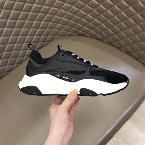 Dior B22 Black Trainer Lateral Side Profile in black and white Lateral side profile of the Dior B22 black trainer held in hand highlighting the side logo plaque in black and white