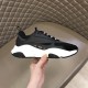 Dior B22 Black Trainer Lateral Side Profile in black and white Lateral side profile of the Dior B22 black trainer held in hand highlighting the side logo plaque in black and white