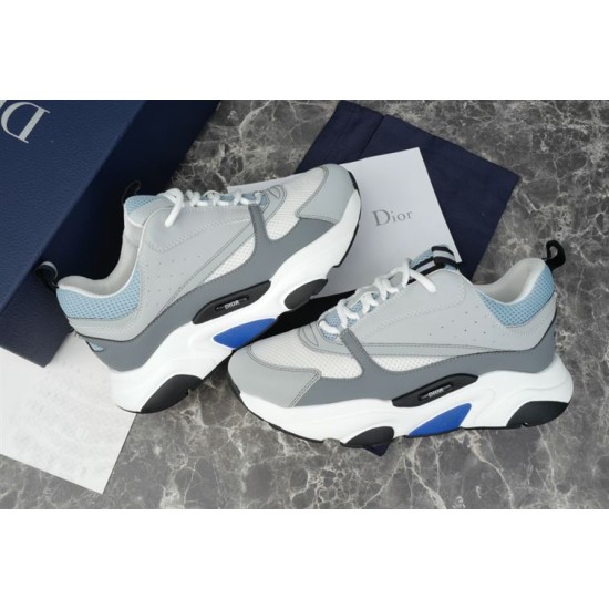 Dior B22 Trainers Pair Display in grey and white Pair of grey white and blue leather mesh trainers displayed next to navy box and card