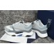 Dior B22 Trainers Side Angle in grey and white Side angled view of grey and blue mesh trainers standing together on marble background in grey and white