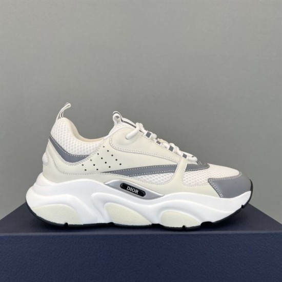 Dior B22 Trainer Lateral View in white and silver Lateral side view of white Dior B22 trainer resting on navy box in white and silver