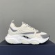 Dior B22 Trainer Lateral View in white and silver Lateral side view of white Dior B22 trainer resting on navy box in white and silver