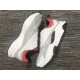 Close-up view of lateral mesh and leather panels on Dior B22 Trainers in white and grey