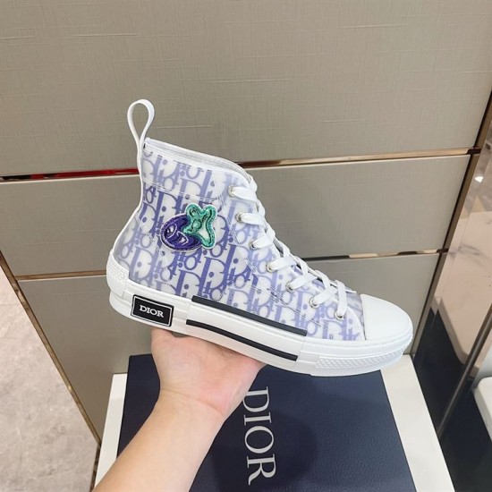 Dior B23 High-Top Trainer Monogram Canvas White Blue Side Angle Handheld side view of Dior B23 High-Top Trainer Monogram Canvas White Blue showing graphic patch