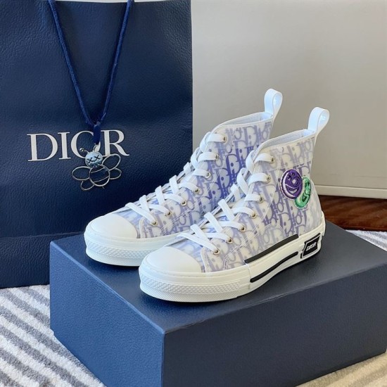 Dior B23 High-Top Trainers Monogram Canvas White Blue Pair Dior B23 High-Top Trainers Monogram Canvas White Blue pair resting on a navy gift box