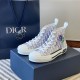 Dior B23 High-Top Trainers Monogram Canvas White Blue Pair Dior B23 High-Top Trainers Monogram Canvas White Blue pair resting on a navy gift box
